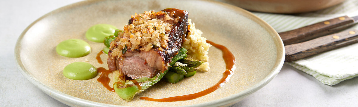 Moroccan mint tea crusted lamb rump with cauliflower cous cous, asparagus, pea puree and lamb sauce