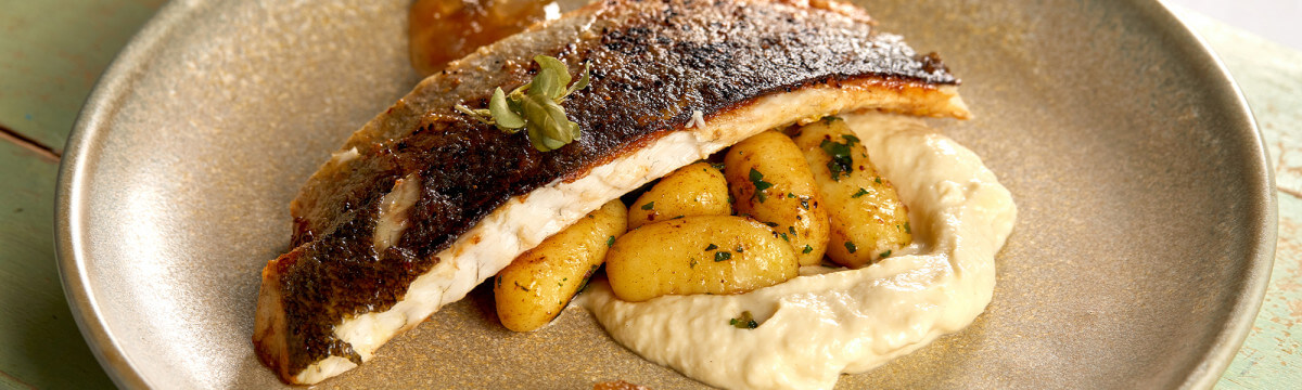 Pan fried sea bass with a herb gnocchi