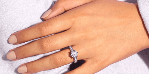 woman's hand wearing engagement ring - she knows the benefits of lab grown diamonds