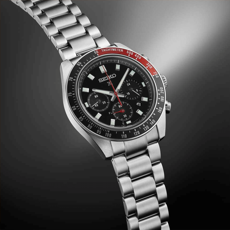Solar Chronograph watch with red aluminium bezel on silver background